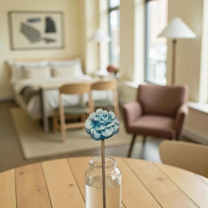 Fleur œillet turquoise dans un vase en verre sur une table en bois, intérieur lumineux